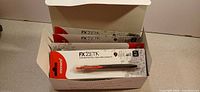 Open master box showing multiple blister-packed Monami FX Zeta F5 pens