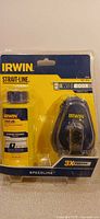 Front view of sealed IRWIN Strait-Line Speedline chalk reel kit showing chalk reel and 4 oz blue chalk bottle