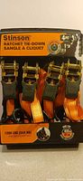 Front view of packaged Stinson 4-pack ratchet tie-downs