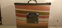 Front view of packaged fleece sheet set showing stripe pattern and label