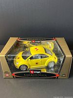 Front and side view of boxed Burago 1:18 Volkswagen Beetle model