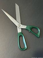 Full view of scissors open, showing blades and handles