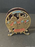 Front view showing Jerusalem skyline design, enamel colors, scrolled feet