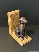 Front three-quarter view of wooden bookend with bronze dog figure