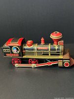 Right side profile of Daimaru tin locomotive showing lithography and wheels