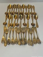 All pieces laid out showing quantity and type (spoons top, forks bottom)
