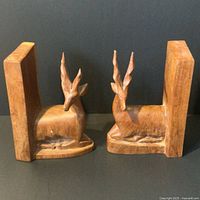 Front view of both carved wood gazelle bookends side by side