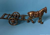 Side view of brass horse with attached cart