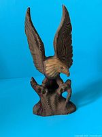 Front view of wooden eagle sculpture with wings raised