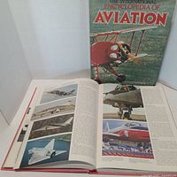 Front view of book with dust jacket and open pages