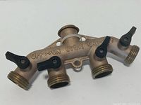 Top view showing four outlets, shut-off levers and brass construction