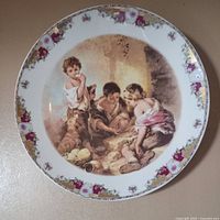 Front view showing Murillo scene and floral gilt rim