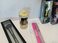 Close-up of Kabuki brush, MUA brush and partial view of other items