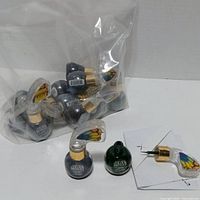 Bag with sealed eyeliner bottles, one opened for display (sample not included) showing bottle shape and applicator