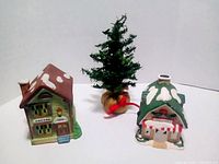 Front view of Doctor and Grocery ceramic houses with tree between