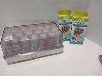 Electric hot roller set with rollers and two packaged Conair Updo Sticks