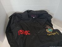 Jacket front showing collar, button front, red USMC embroidery and eagle-globe-anchor with Semper Fi text