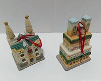 Front and side view of both ceramic church ornaments showing overall shape, paint and hanging ribbons