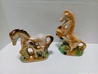 Front view of both ceramic horse figurines