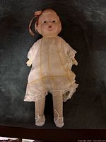 Front view of Dee & Cee composition doll in dress