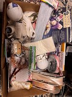 Overview of box showing ribbons, lace, pipe cleaners, Bottle Buddies kit, foam balls