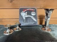 Overall lot showing packaged corkscrew, two candlesticks, bud vase
