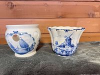 Both Delft Blue ceramic pieces side by side
