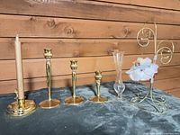All items in lot: four candlestick holders, taper candle, glass vase, ornament stand with hanging flower