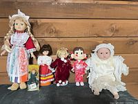 Group shot of all six dolls showing relative sizes and costumes