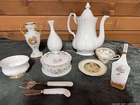 Group shot of ten bone china pieces including teapot, vases, bowl, dish, teacup, saucer, cake server, forks