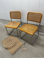 Front view of both Cesca chairs with repair materials on floor