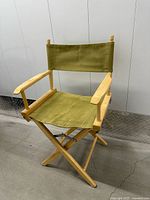 Front view of wood director chair with green canvas upholstery