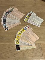 Three groups of G.I. Joe file cards spread on wood surface