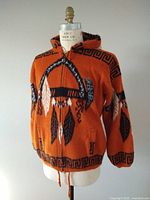 Front view of orange wool hooded sweater on mannequin