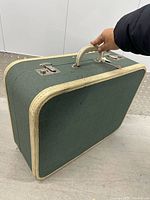 Full view showing suitcase profile, handle, latches, trim color contrast