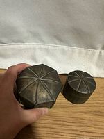 Octagonal and cylindrical brass boxes with lids closed