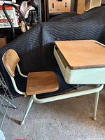 Side view showing attached chair, metal frame and wood seat