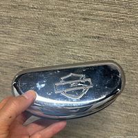 Front view of chrome eyeglass case with Harley logo