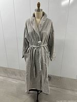 Front view of grey fleece robe on dress form showing collar, belt and pockets