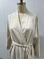 Front view of cream jacquard kimono robe on dress form