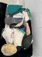assorted shoulder pads in plastic bag on black surface