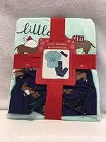 Front view of packaged 3-piece Christmas dog print pajama set showing top, pants illustration and red ribbon