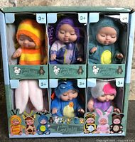 Front of boxed set showing all six Doll Lovely mini dolls in individual windows