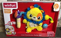Front of sealed Winfun Lion Comforter Rattle Set showing all three rattles in packaging