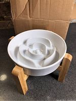 Ceramic slow feeder bowl on bamboo stand