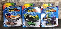 Front view of three sealed Color Shifters cars: Track Tune, Vampyra, HW Dog