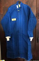 Full view of blue Oberon arc flash coat hanging