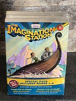 Front of sealed box set showing title, branding, and promotion details