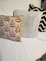 Front view of all three pillows on white bedspread
