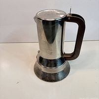 Full view of Alessi 9090 espresso maker showing body, base and handle